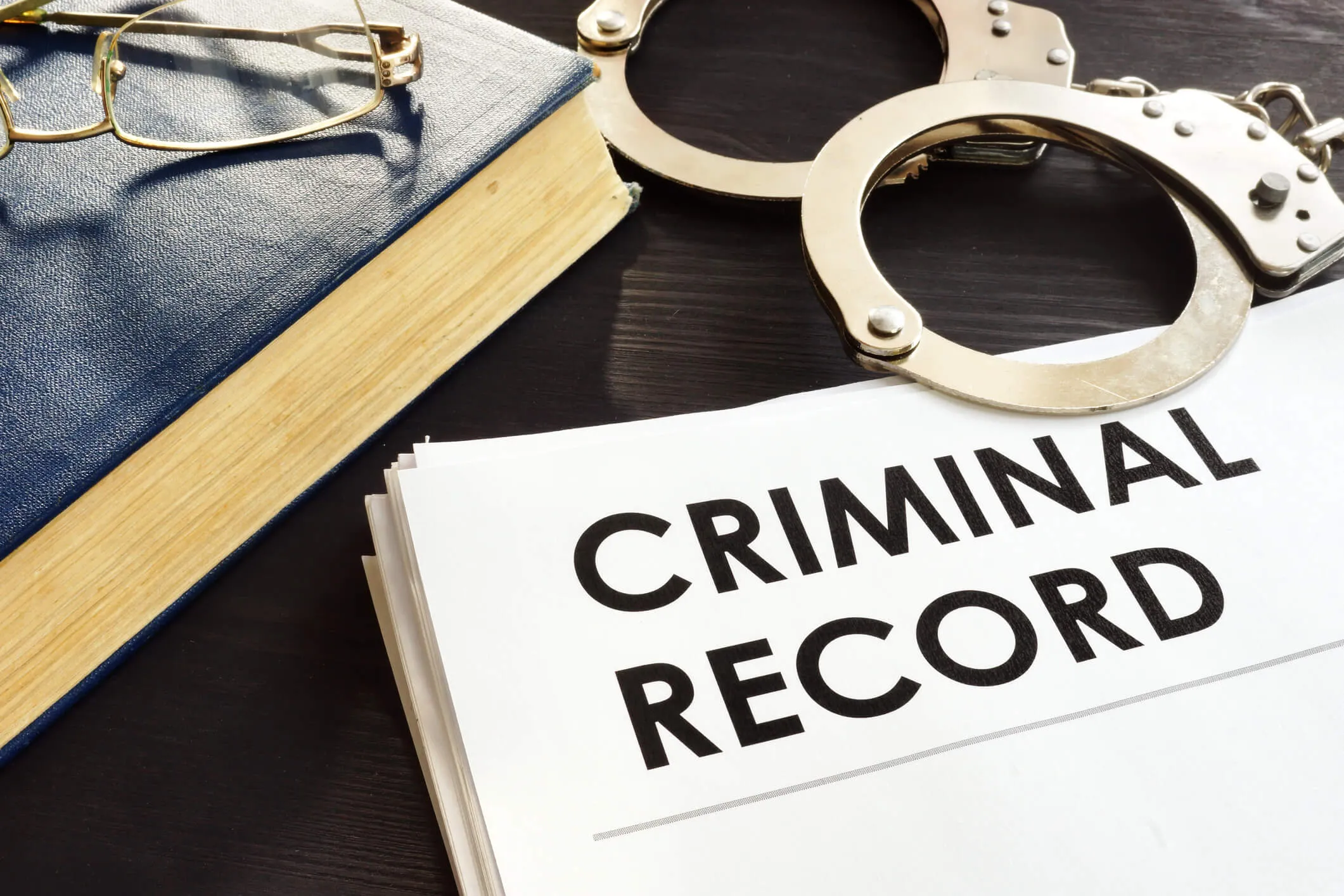 Criminal record under handcuffs.