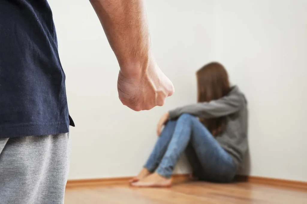 A man with his fist clenched in front of a female.